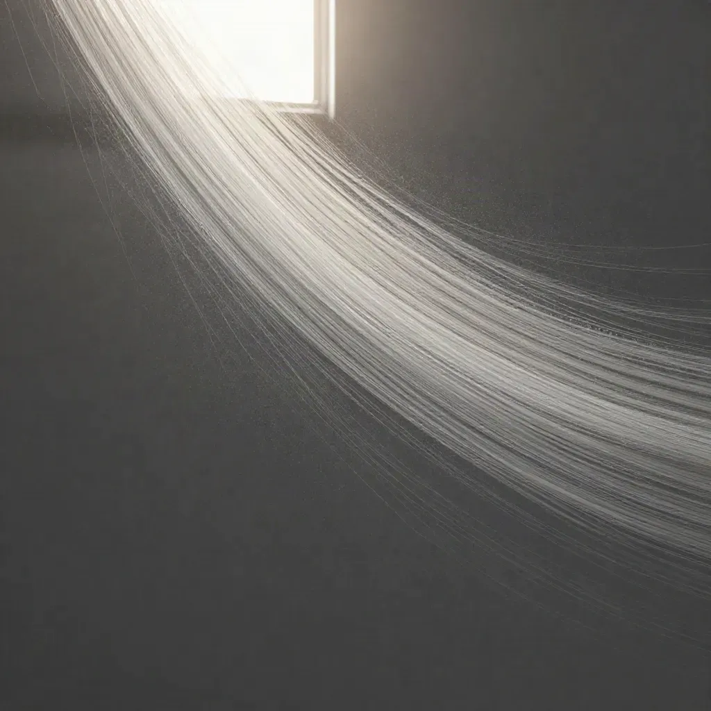 Silver filaments bloom in graphite haze with a calm empty lower third for copy.